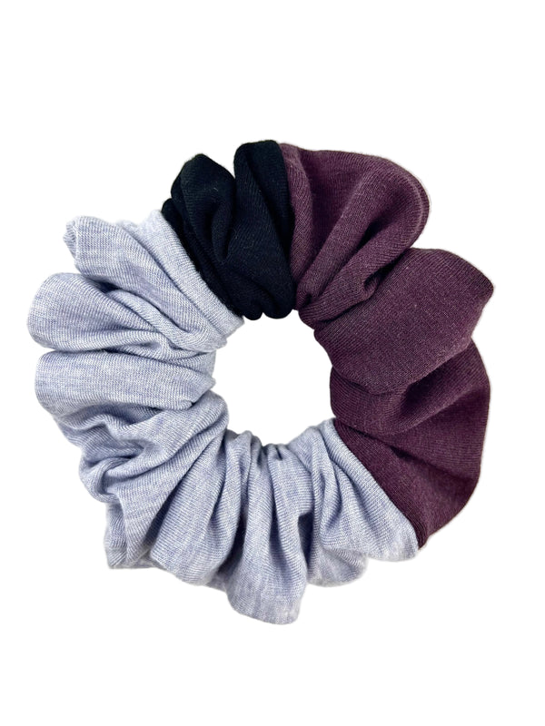 Scrunchie with colour block in gray, black, and purple on a white background