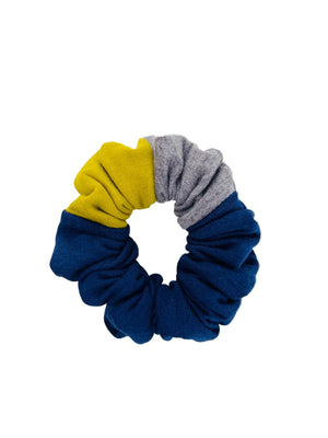 A scrunchie in blue, yellow, and gray on a white background