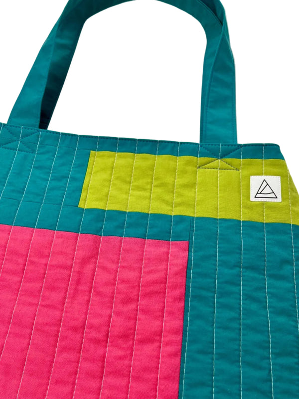 Colorful quilt with geometric pattern on a white background