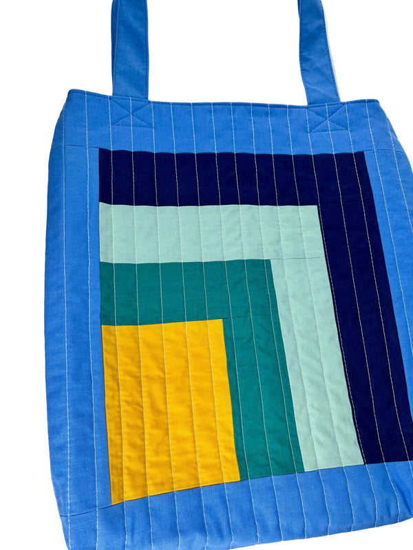 Quilted tote bag with geometric pattern on a white background