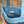 Blue quilted tote bag with colorful stripes on a natural background