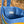 Blue quilted bag with colourful stripes on a natural background