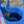 Close-up of a blue bag with a colorful interior, outdoors.