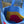 Close-up of a blue bag with colorful interior lining, blurred background