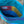 Close-up of a colorful quilted fabric with geometric pattern on a natural background